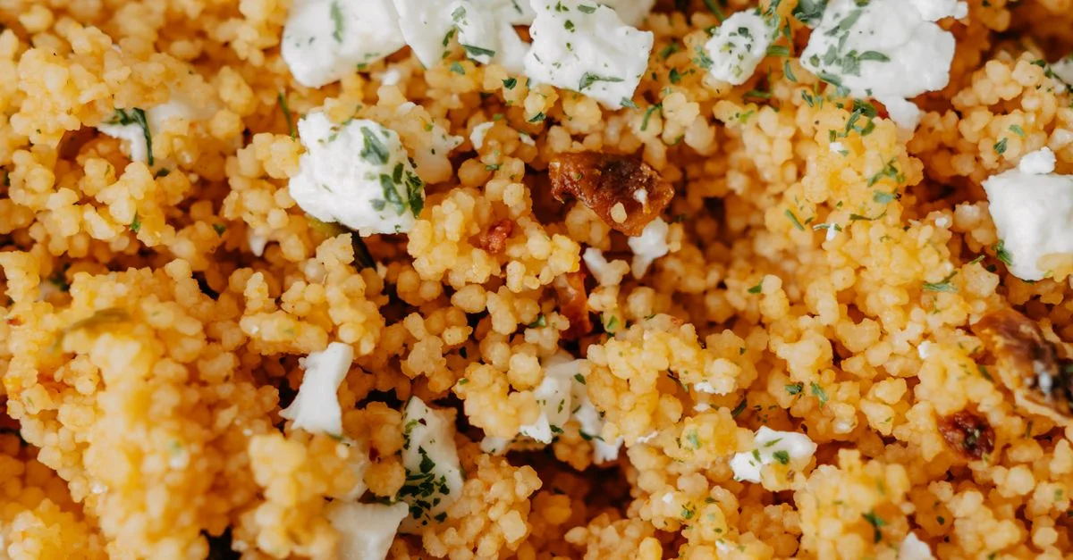 Délicieuse salade de couscous garnie de fromage et d'herbes. Un plat fait maison parfait avec des ingrédients frais.